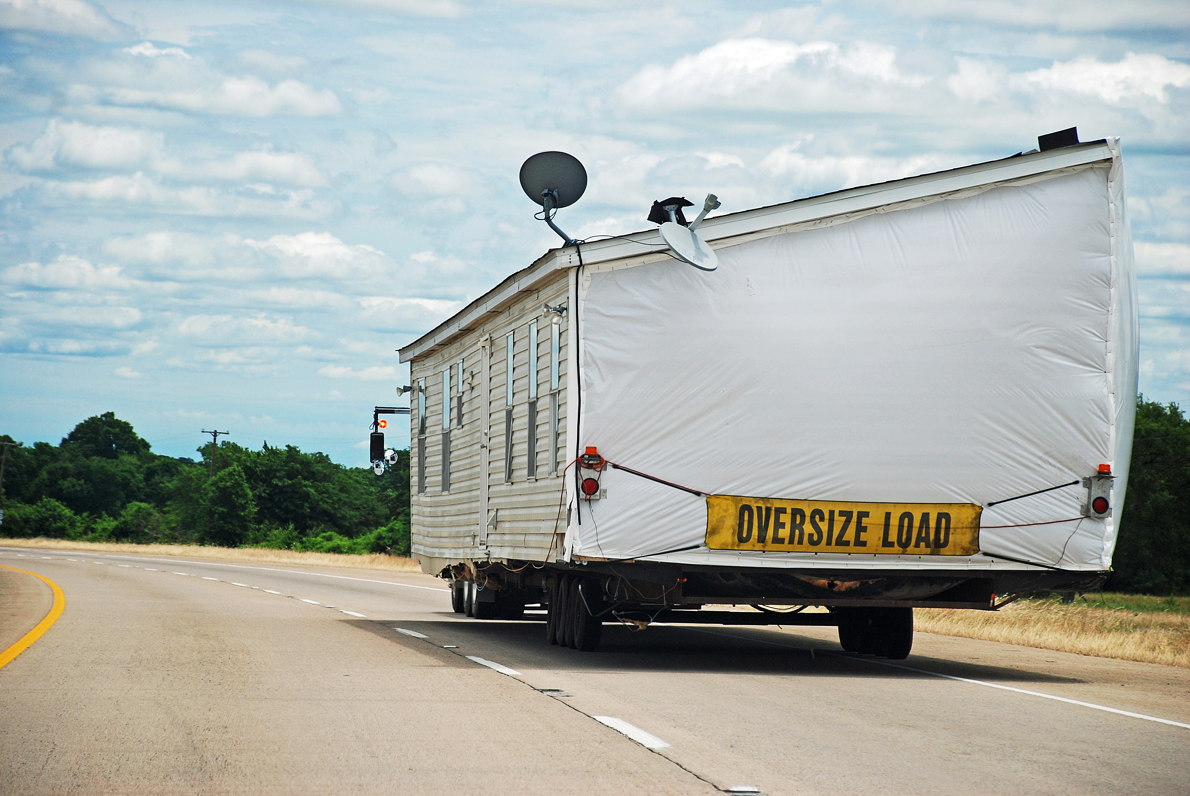 Side view of a manufactured home being transported